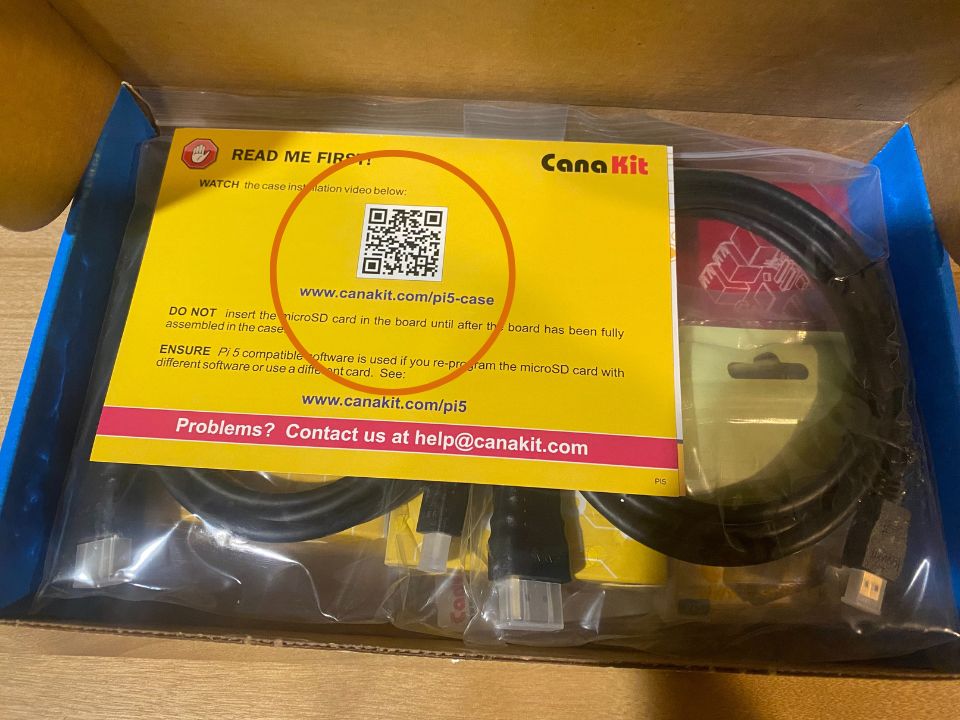 Inside of the CanaKit Raspberry Pi Starter Kit PRO, emphasizing that there is an assembly video that needs to be watched, even if you are an experienced electronics person.